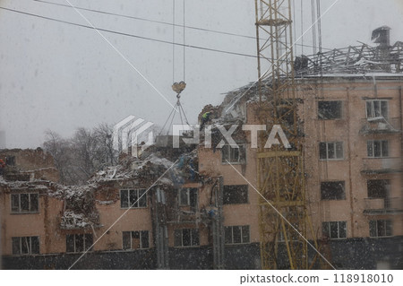 Destroyed building, winter day, first snow, First snow, abandoned city, depressive city atmosphere, war in Ukraine  118918010