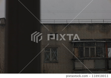 First snow in a Ukrainian city, a depressed post-Soviet city, Heavy snowfall in a dark gloomy poor city, Former Soviet Union  118918011