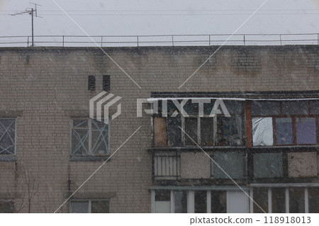 First snow in a Ukrainian city, a depressed post-Soviet city, Heavy snowfall in a dark gloomy poor city, Former Soviet Union  118918013