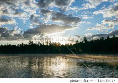 Misty sunrise over a lake. A foggy morning on autumn by a small lake. Misty reflection in water. Dreamy wanderlust, web banner 118918057