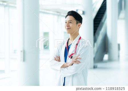 A man in a white coat working in a medical facility A man in a white coat working in a medical facility 118918325