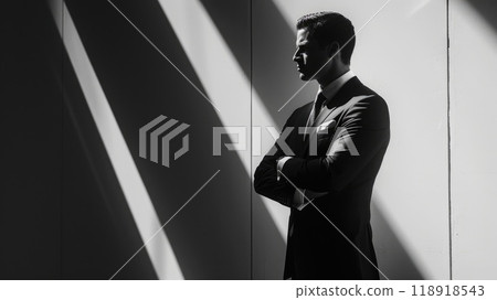 Modern Man in Power Suit - Confident Businessman Leaning Against Wall in Black and White Silhouette 118918543