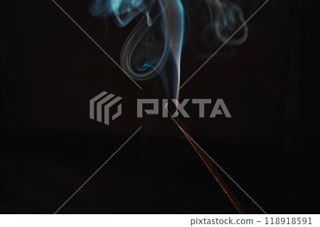 Aroma sticks smoke on black background with white backlit. Incense burning smoke fumes and wisps. Burning aromatic incense smoky stick for meditation and relaxing. Aromatherapy smokes for yoga. Aroma sticks smoke on black background with white backlit. Incense burning smoke fumes and wisps. Burning aromatic incense smoky stick for meditation and relaxing. Aromatherapy smokes for yoga. 118918591