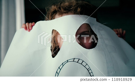 Little girl scares off wearing DIY paper phantom mask for Halloween Little girl scares off wearing DIY paper phantom mask for Halloween 118918929