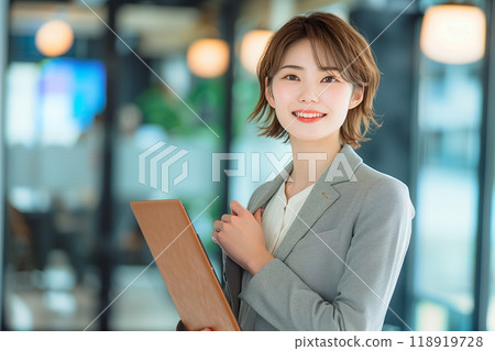 Smiling businesswoman posing with her fist in the air 118919728