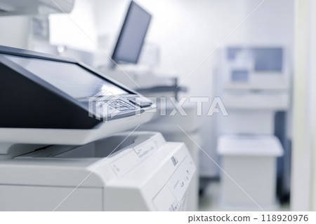 Modern office equipment in a bright workspace focusing on copiers and printers during a quiet afternoon 118920976