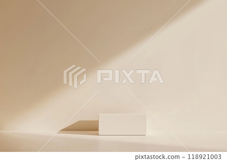 A minimalist composition showcasing a plain white block casting a shadow on a softly lit beige wall 118921003