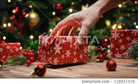 Christmas gifts with decorative paper under the tree Christmas gifts with decorative paper under the tree 118921320