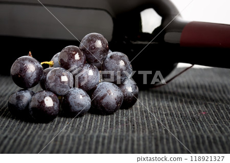 Black grapes and a bottle of red wine 118921327