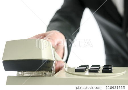 Business man hanging up telephone receiver Business man hanging up telephone receiver 118921335