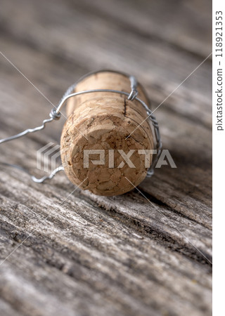 Champagne cork lying on wooden boards Champagne cork lying on wooden boards 118921353