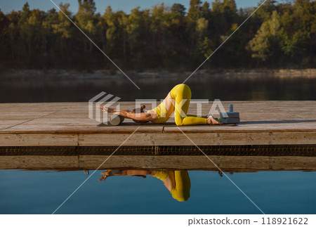 Engaging in Yoga Practice by the Water A Space for Tranquil Reflection and Flexibility 118921622
