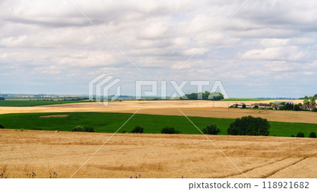 Panoramic view of the countryside with a blue sky and white clouds in the background Panoramic view of the countryside with a blue sky and white clouds in the background 118921682