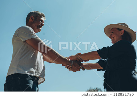Couple hands held together on blue sky background, close up Couple hands held together on blue sky background, close up 118921780