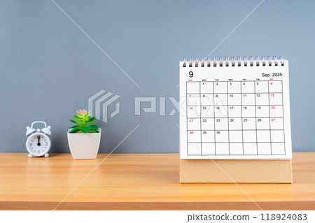 September 2025, Monthly desk calendar for 2025 year on wooden table with grey background. 118924083