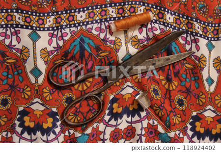 Brown Thread With Thimble and Scissors on Vintage Fabric Brown Thread With Thimble and Scissors on Vintage Fabric 118924402