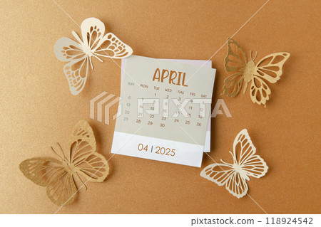 April 2025 calendar card with butterfly paper on orange. 118924542