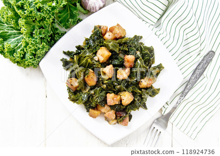 Kale cabbage with bacon in plate on light board top Kale cabbage with bacon in plate on light board top 118924736