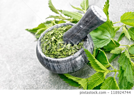Nettle dried in mortar on stone countertop Nettle dried in mortar on stone countertop 118924744