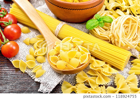 Pasta different with tomatoes on dark board Pasta different with tomatoes on dark board 118924755
