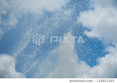 Water splashing against the summer sky Water splashing against the summer sky 118925163