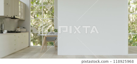 Modern, bright home corridor leading through the kitchen features an empty white mockup wall. 118925968