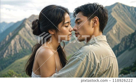 a romantic scene. A beautiful young Asian couple in love tenderly embraces against the backdrop of a mountain landscape. High quality photo a romantic scene. A beautiful young Asian couple in love tenderly embraces against the backdrop of a mountain landscape. High quality photo 118926222