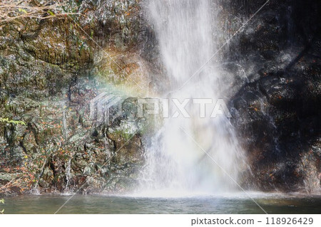 A faint rainbow created by the mischief of the sun and the spray from the waterfall A faint rainbow created by the mischief of the sun and the spray from the waterfall 118926429