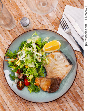 Roasted porbeagle steak with green salad and lemon Roasted porbeagle steak with green salad and lemon 118926710