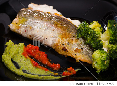 Grilled trout on black dish with broccoli and tartar sauce Grilled trout on black dish with broccoli and tartar sauce 118926790