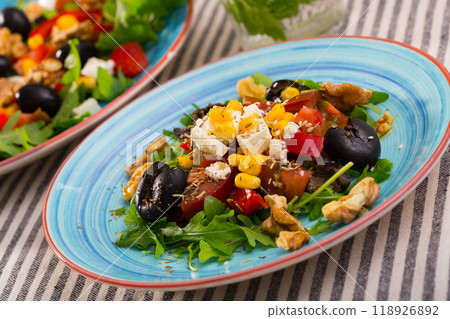 Arugula salad with vegetables, cheese, walnuts Arugula salad with vegetables, cheese, walnuts 118926892