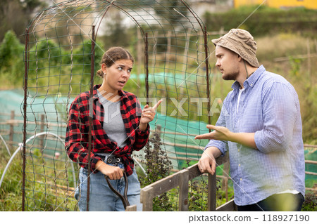 European woman and man neighbors quarrel and swear at village European woman and man neighbors quarrel and swear at village 118927190