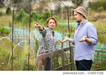 European woman and man neighbors quarrel and swear at village European woman and man neighbors quarrel and swear at village 118927206
