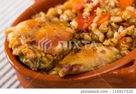Chicken thighs with barley porridge in clay pot Chicken thighs with barley porridge in clay pot 118927320