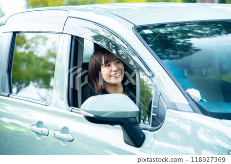 A woman driving a car A woman going for a drive 118927369