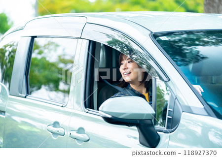 A woman driving a car A woman going for a drive 118927370