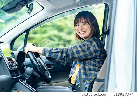 A woman driving a car A woman going for a drive A woman driving a car A woman going for a drive 118927374