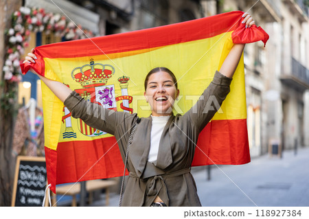 Young smiling woman holding Spain flag 118927384