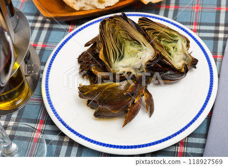 Delicious fried artichoke halves on a white plate 118927569