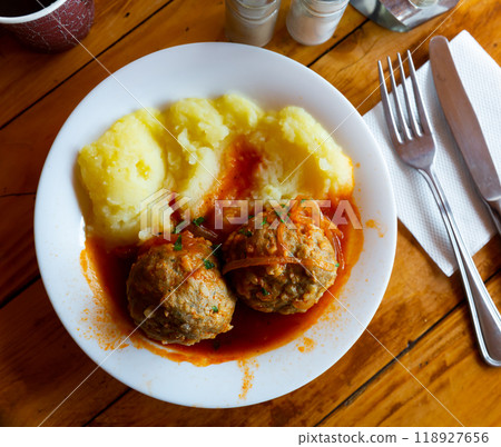 Fresh hot mashed potatoes and meatballs with gravy on plate. Russian cuisine 118927656