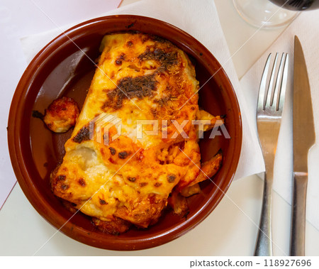 Top view of traditional italian meat lasagna with grated cheese served in clay plate Top view of traditional italian meat lasagna with grated cheese served in clay plate 118927696