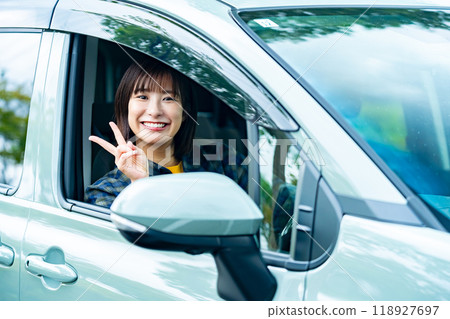 A woman driving a car A woman going for a drive A woman driving a car A woman going for a drive 118927697