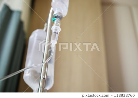 Close up medical intravenous IV drip in hospital background 118928760
