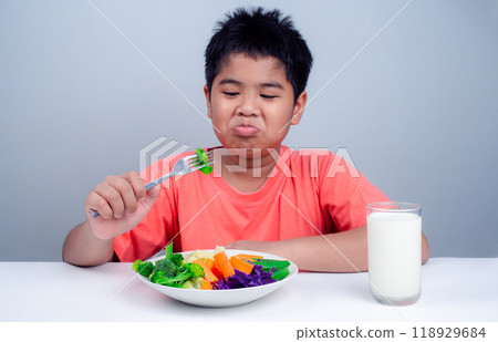 Children do not like to eat vegetables, Little cute boy refuses to eat healthy vegetables, Nutrition healthy eating habits for kids concept, Children do not like to eat vegetables. Children do not like to eat vegetables, Little cute boy refuses to eat healthy vegetables, Nutrition healthy eating habits for kids concept, Children do not like to eat vegetables. 118929684