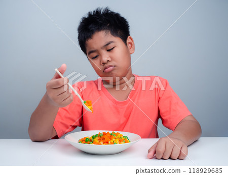 Children do not like to eat vegetables, Little cute boy refuses to eat healthy vegetables, Nutrition healthy eating habits for kids concept, Children do not like to eat vegetables. Children do not like to eat vegetables, Little cute boy refuses to eat healthy vegetables, Nutrition healthy eating habits for kids concept, Children do not like to eat vegetables. 118929685