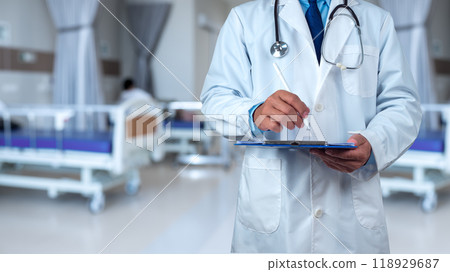 Doctor with stethoscope in white coat holding clipboard standing on the background inside a hospital, Writing medical record diagnosis, Close up, Healthcare and medicine, Concept of treating disease. Doctor with stethoscope in white coat holding clipboard standing on the background inside a hospital, Writing medical record diagnosis, Close up, Healthcare and medicine, Concept of treating disease. 118929687