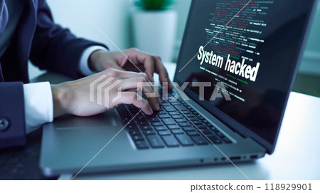 Close-up view of hands typing on laptop with screen showing cyber attack message, red and white text alerting system hack, concept of data protection failure, cybersecurity threat illustration Close-up view of hands typing on laptop with screen showing cyber attack message, red and white text alerting system hack, concept of data protection failure, cybersecurity threat illustration 118929901