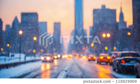 blurred Winter evening in urban setting, snow road and vehicles, glowing sunset behind skyscrapers creating serene atmosphere, empty snow covered sidewalks, city life in cold season blurred Winter evening in urban setting, snow road and vehicles, glowing sunset behind skyscrapers creating serene atmosphere, empty snow covered sidewalks, city life in cold season 118929909