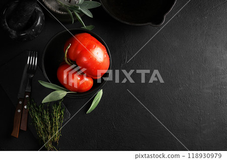 Big red tomato in black bowl on black background. top view, copy space Big red tomato in black bowl on black background. top view, copy space 118930979
