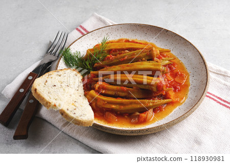 Close up of Okra dish with tomato sauce on gray background, copy space Close up of Okra dish with tomato sauce on gray background, copy space 118930981